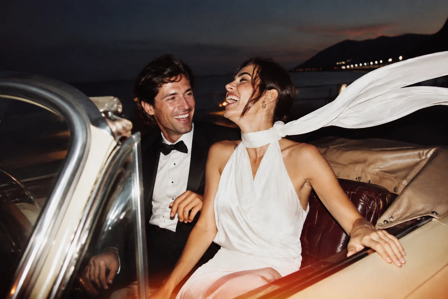 A couple leaving their wedding in a vintage car.